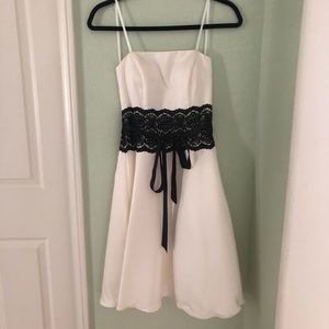Beautiful silky ivory party dress with black lace.